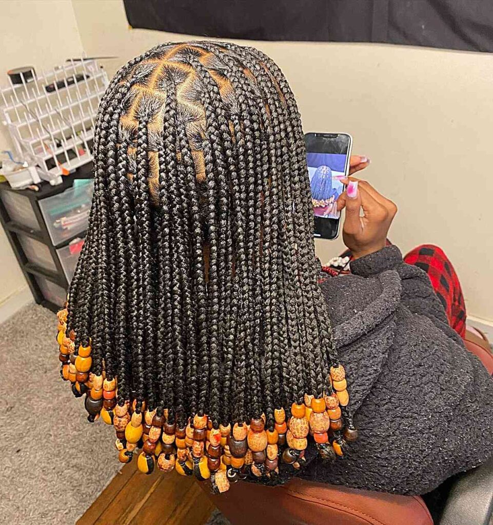 Shoulder Length Black Braids With Orange Beads